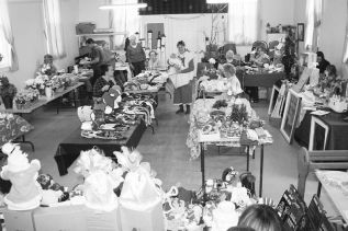 Mrs. Claus (aka Rosie LaPointe), holding baby Addy, organized the craft and bake sale that filled Oddfellows Hall in Parham Saturday.